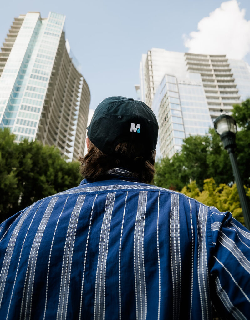 A person wearing a dark cap